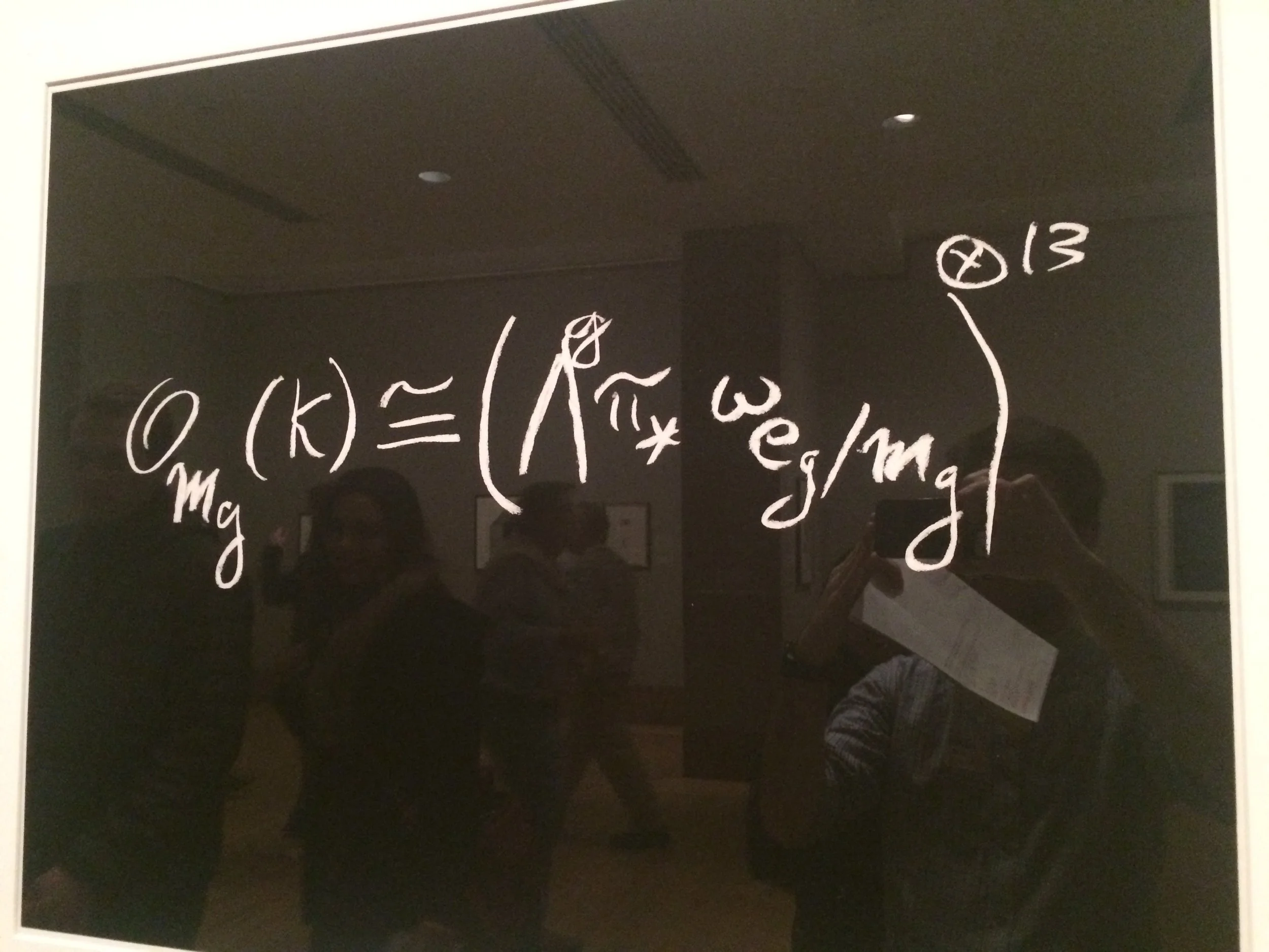 David Mumford’s handwritten formula for the canonical bundle of the moduli space of curves, written in white on black.