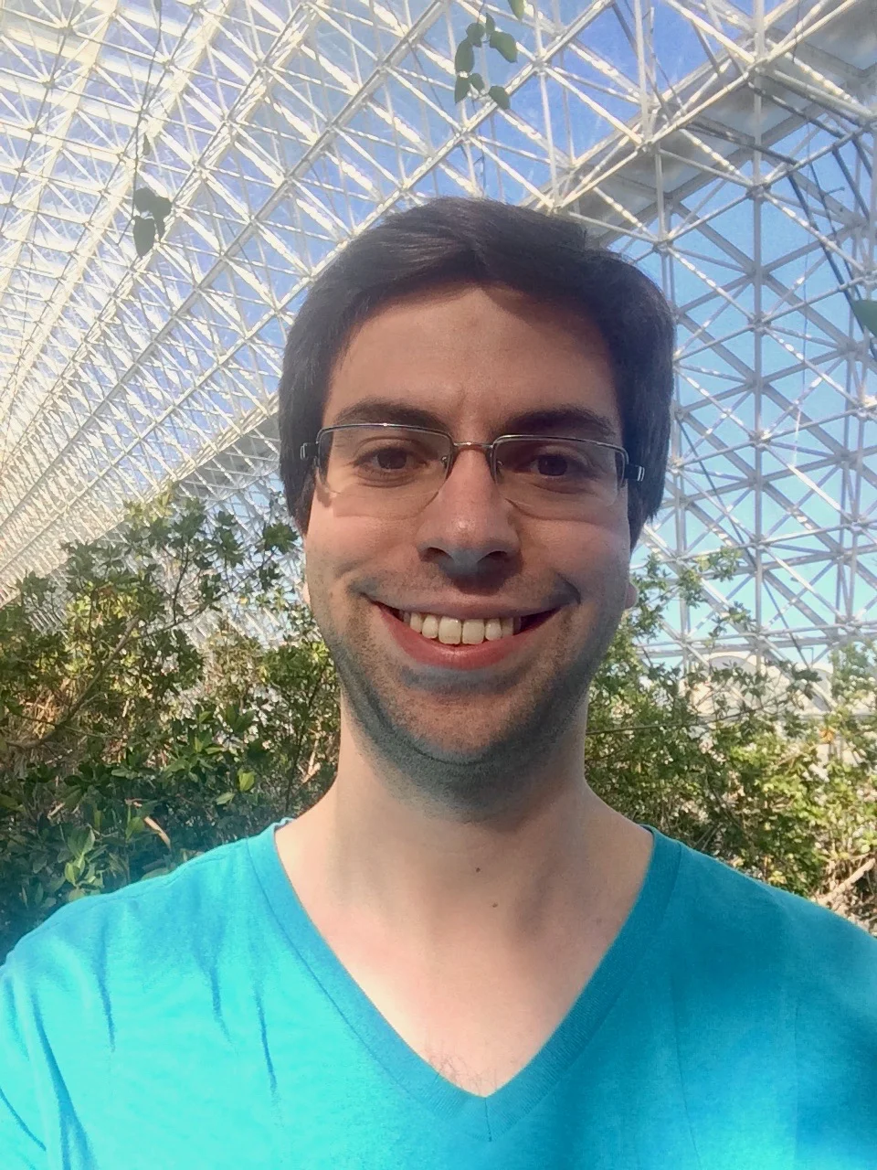 Daniel Litt smiling beneath the glass roof of the savanna biome.