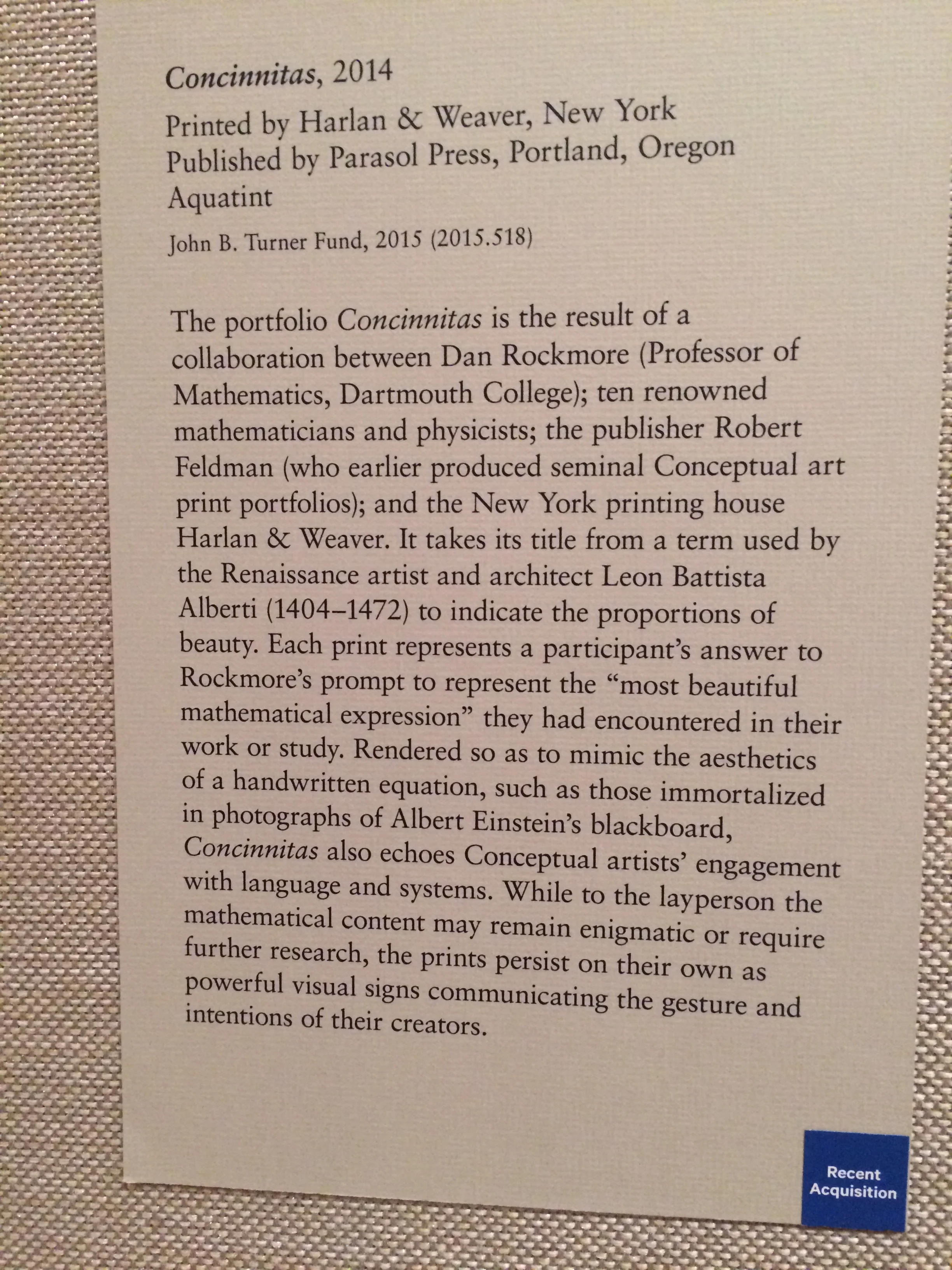 Museum placard describing Concinnitas, a 2014 portfolio in which mathematicians and physicists rendered the mathematical expressions they found most beautiful.